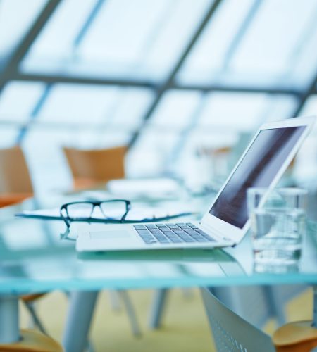 Laptop and other business objects on workplace